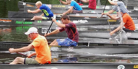 people paddling in canoes