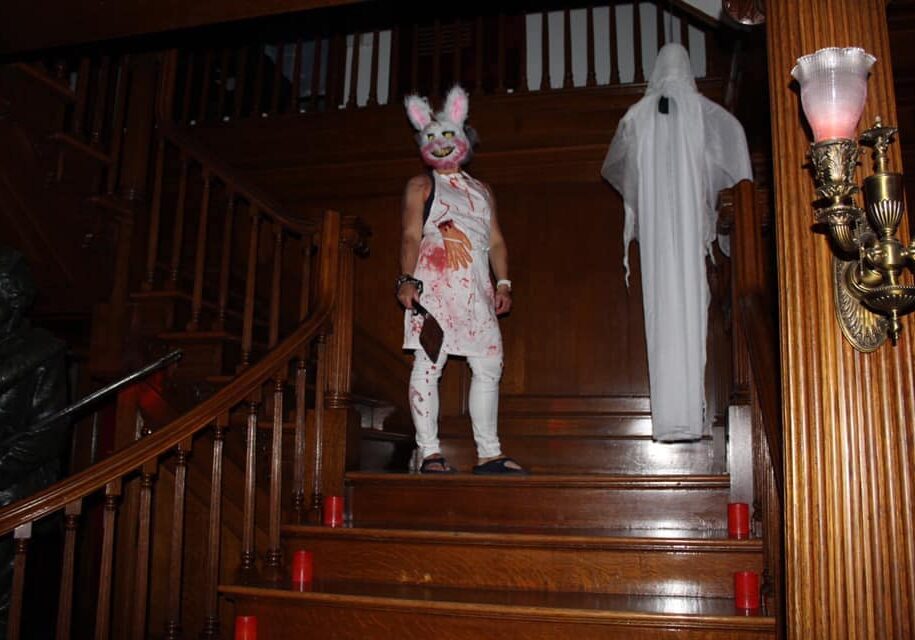 scary person in bunny costume standing atop the remington stairs