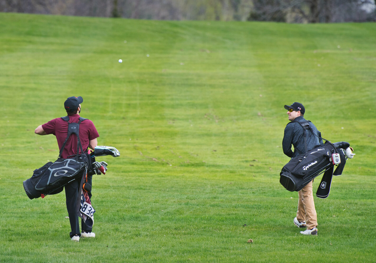 CHRISTOPHER LENNEY/WATERTOWN DAILY TIMES

Austin Sharp, toss a golf ball to Joshua Truax as they two men make their way down the fairway after teeing off the tenth hole, Tuesday, May 7, 2019, at Massena Country Club.