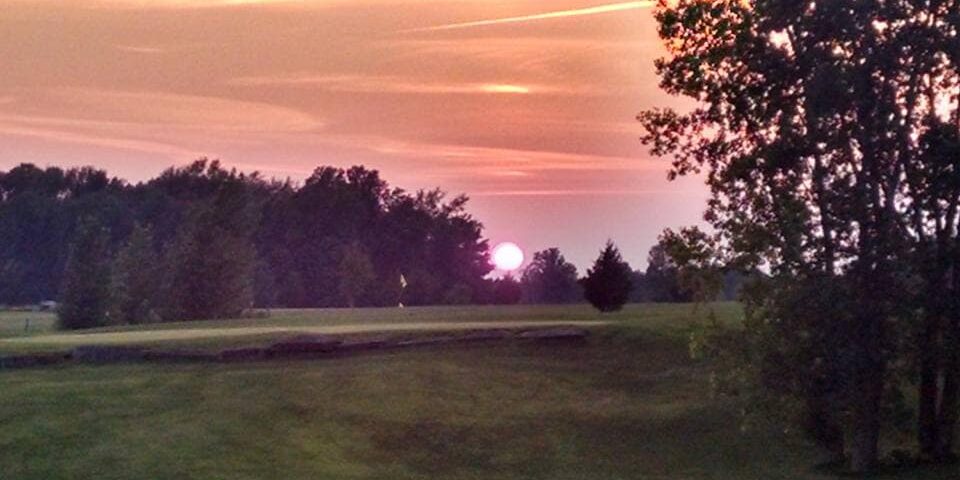 golf course view at sunset with pink sky