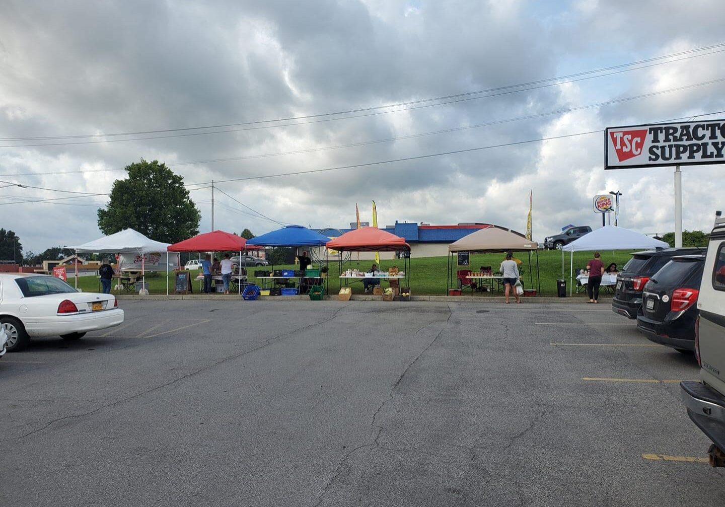 farmers market stalls set up in a parking lot in massena